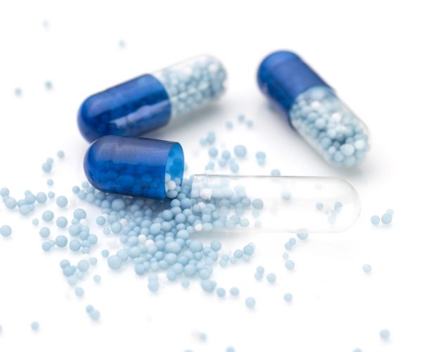 Blue capsules and pills background